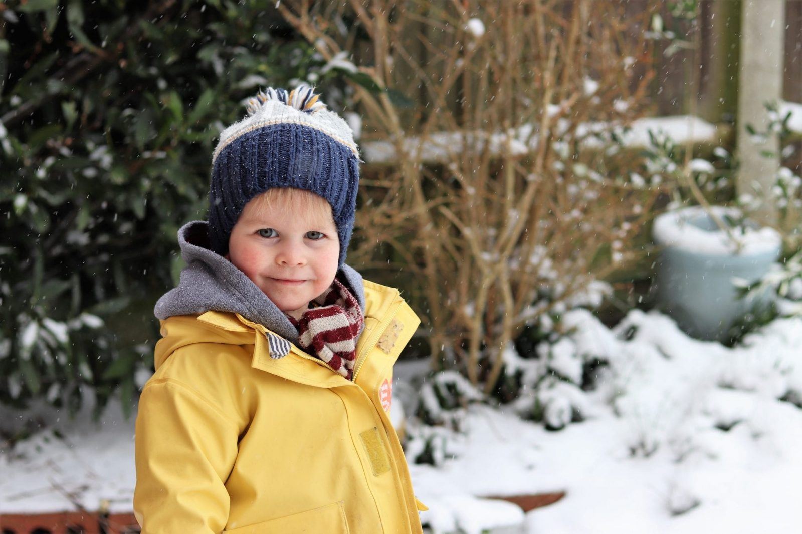 favourite moments of 2018 snow day boy having fun in the snow with yellow coat on