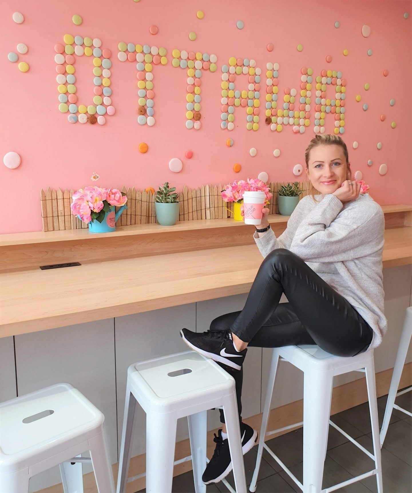 lady holding macaron from Quelque Chose in Canada