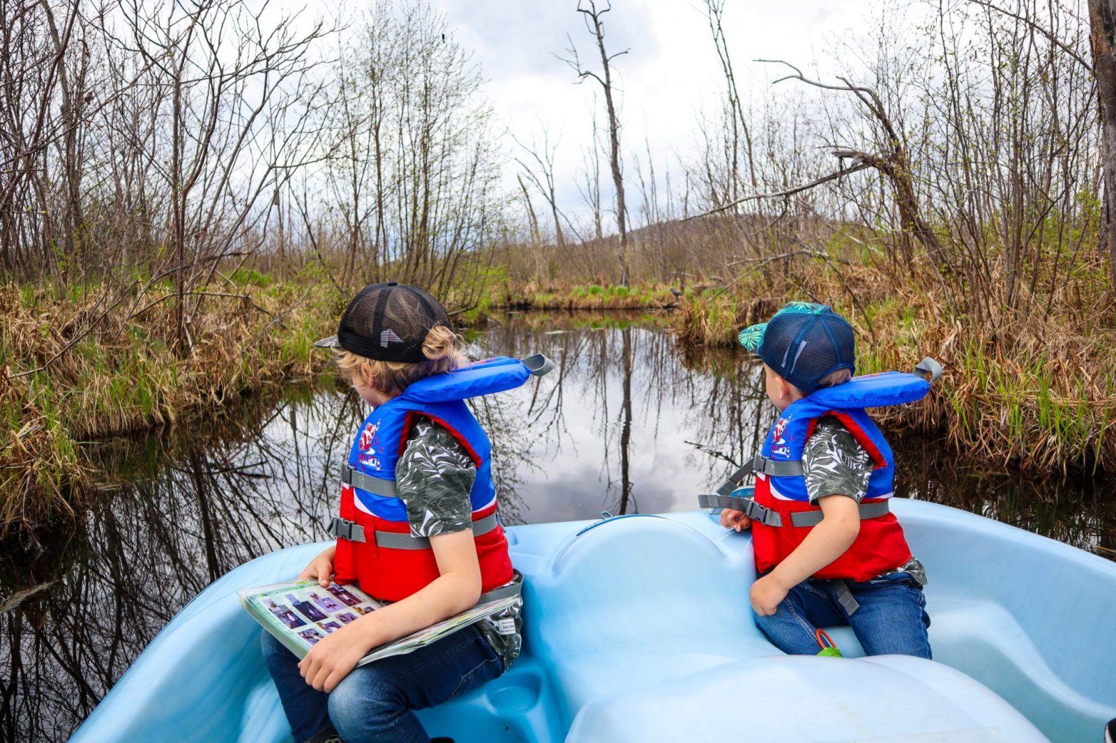 Little boys looking out of pedal boat on Eco Odyssee in Wakefield