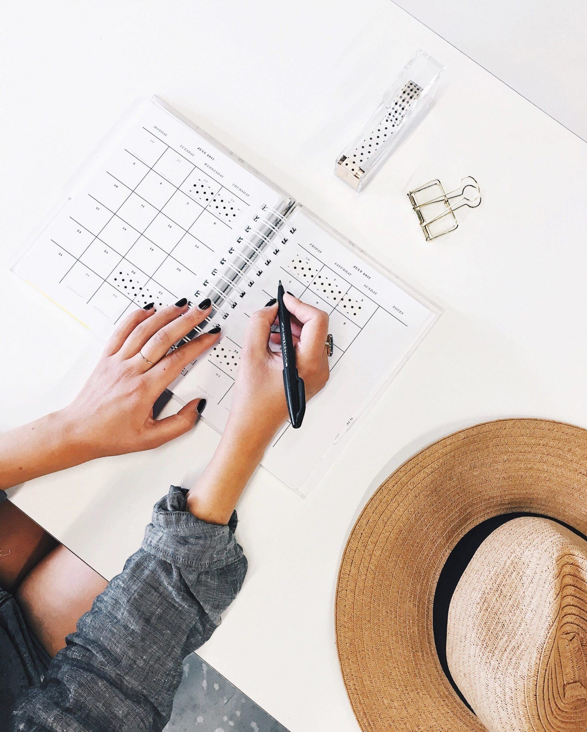 person writing in a book to represent the cost-of-living-crisis and writing down side hustle ideas to earn more money