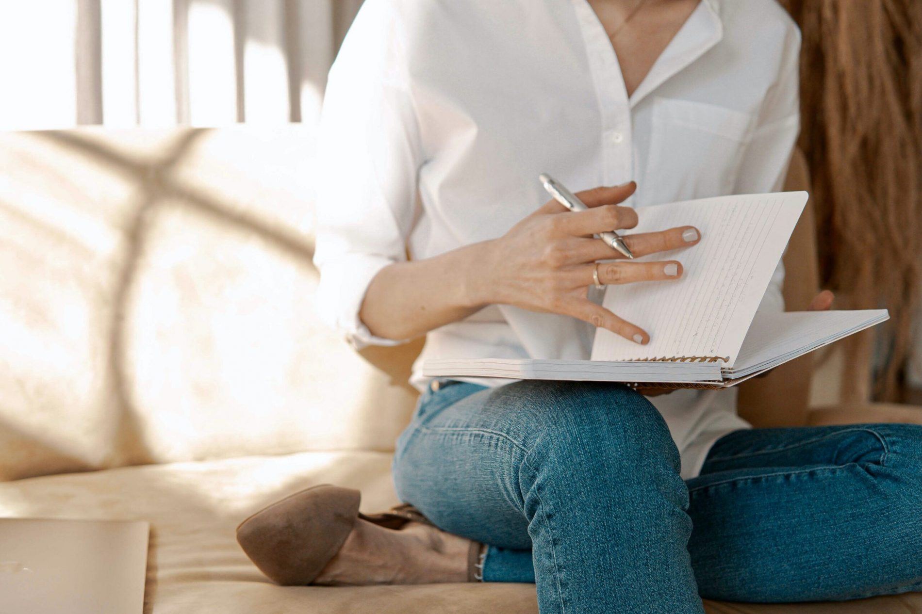 person writing in book