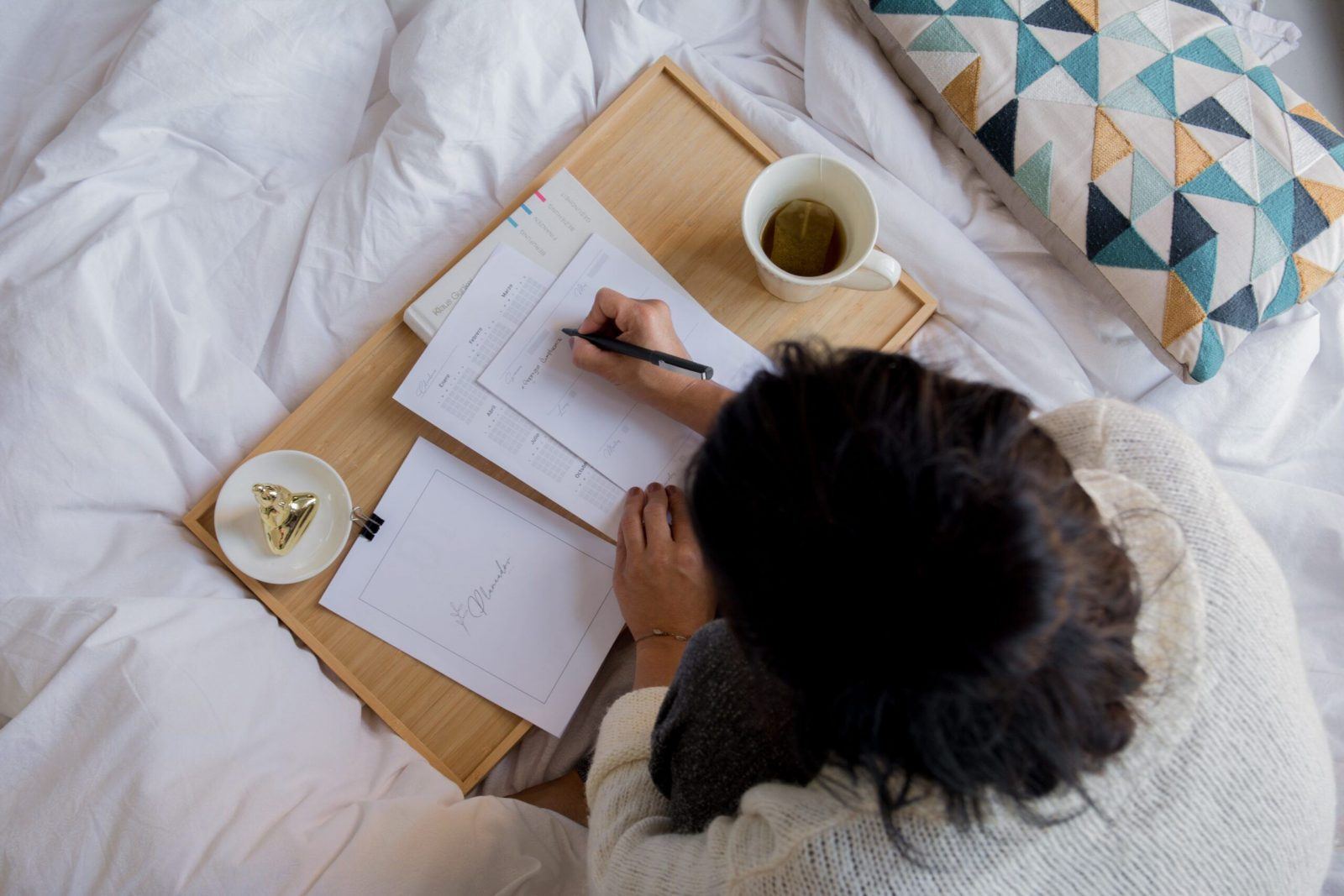 woman looking at paperwork to save money by budgeting showing how frugal living tips can help save money