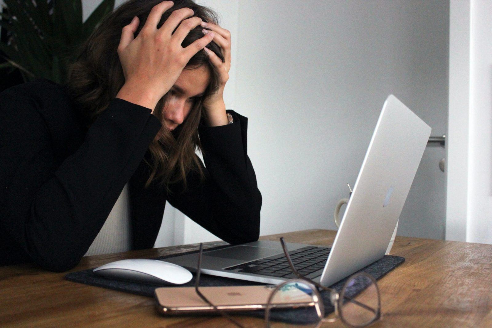 woman looking stressed looking at Laptop with online courses on financial education.
