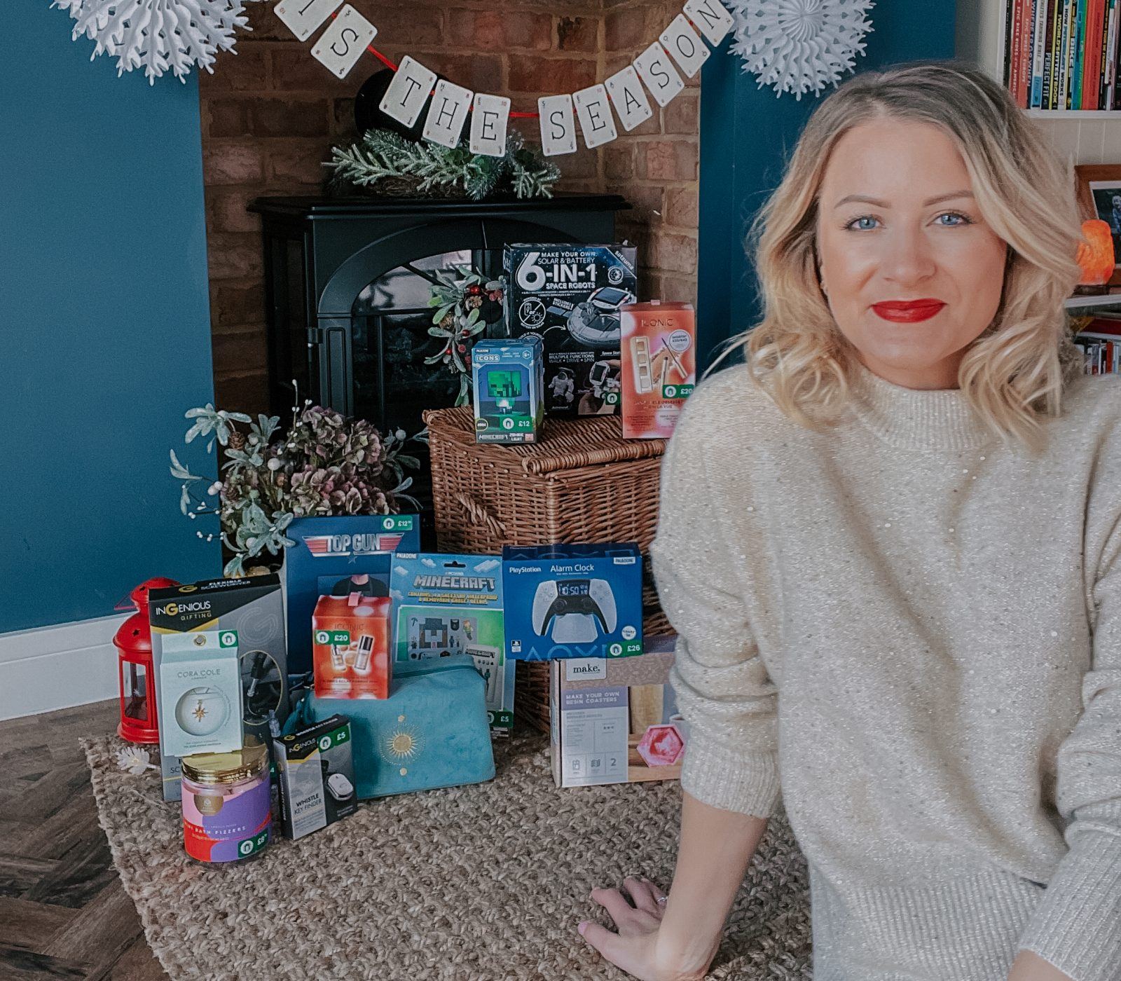 lady sat in front of Christmas presents for all budgets