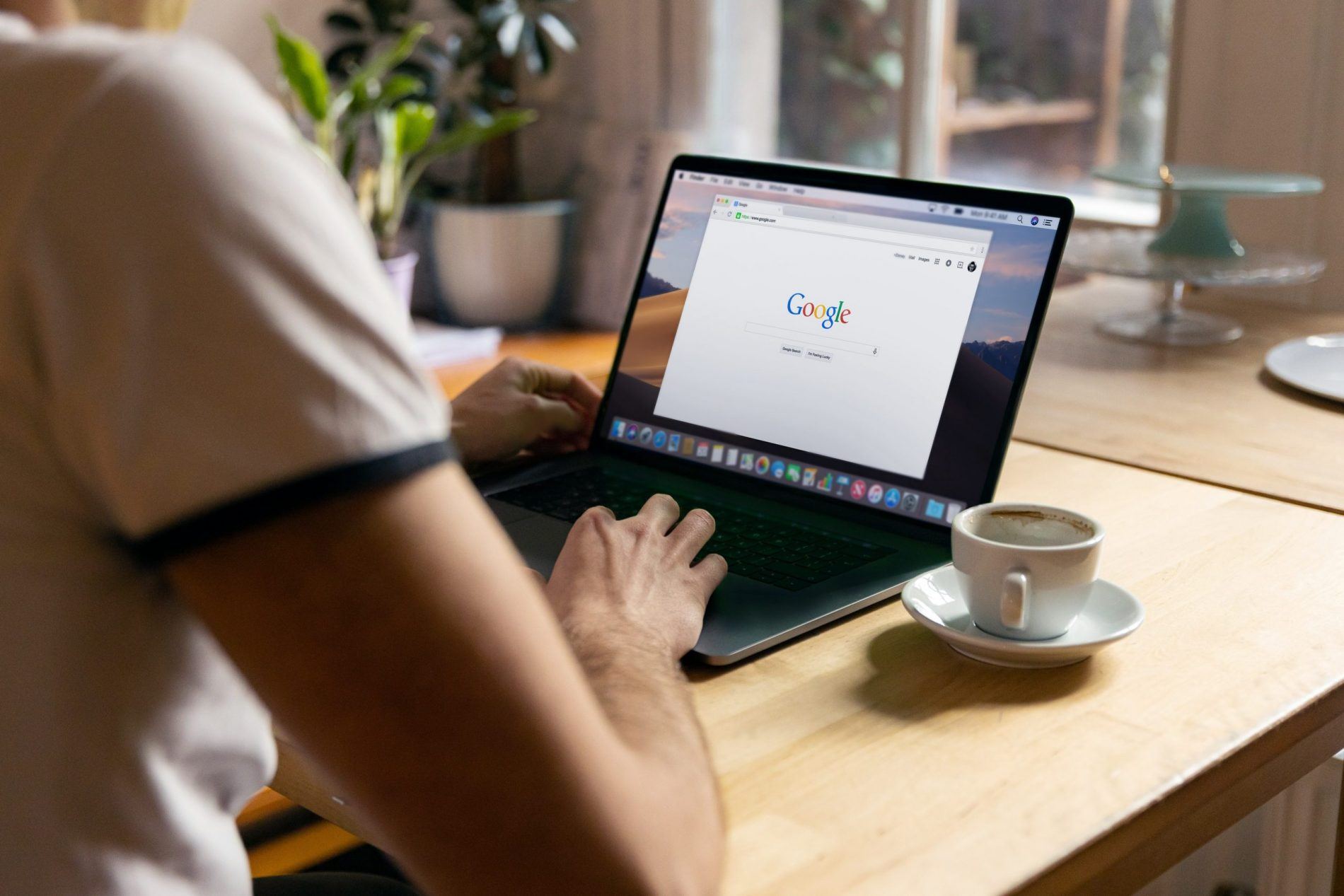 A person using Google at a laptopn, representing the concept of financial independence