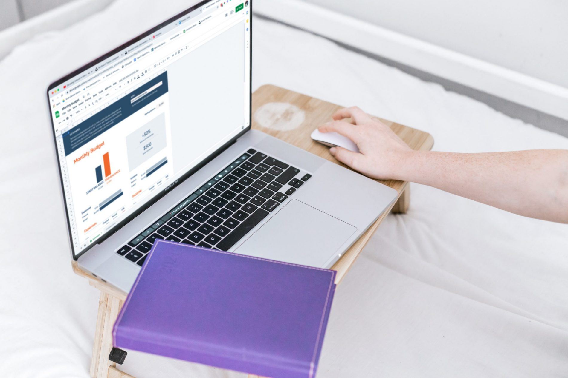 A person at their laptop highlighting the importance of calculating your income and expenses when budgeting to stay on track and save money for financial independence