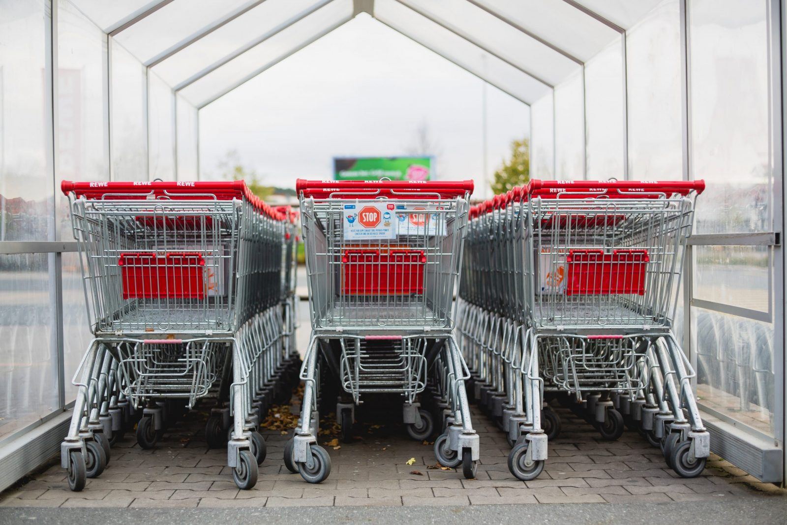 trollies lined up at a supermarket to demonstrate saving money when shopping for groceries in a UK supermarket, implementing money-saving tips
