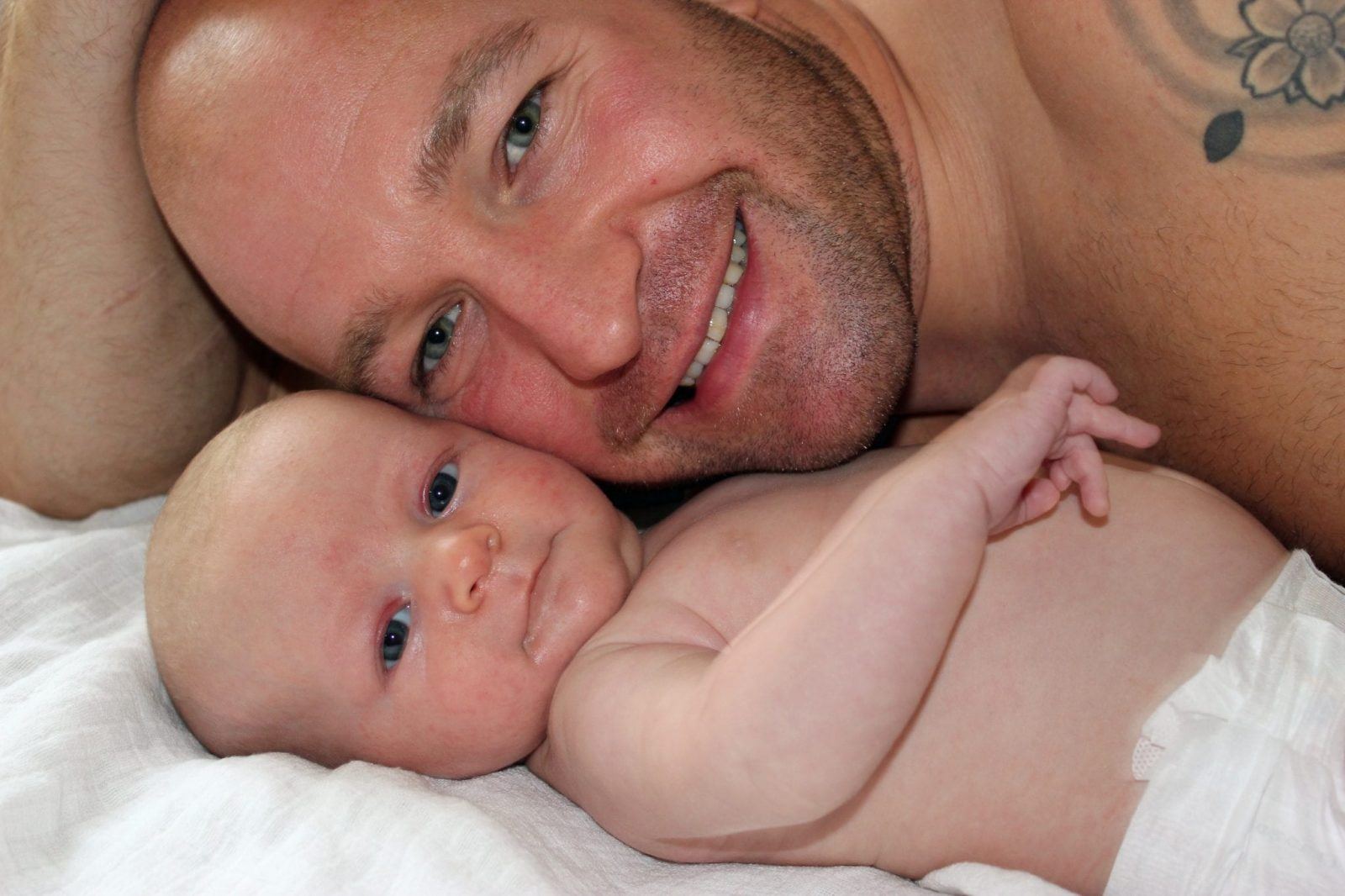 newborn baby smiling with father